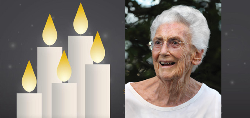 A set of five lit candles with glowing yellow flames is on the left, and an elderly woman with short white hair, wearing glasses and a white top, is smiling on the right. The background is dark, highlighting the woman and candles.