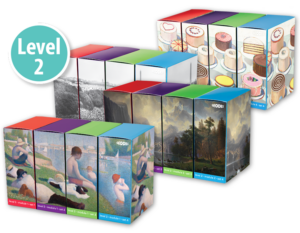 A collection of colorful boxed sets with different designs, marked as Level 2. The designs include cakes, historical photographs, fine art paintings of landscapes, and people in various settings. The boxes are arranged in three rows.