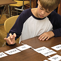 Boy tapping out syllables