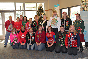 Wilson employees wearing their finest ugly sweaters for charity