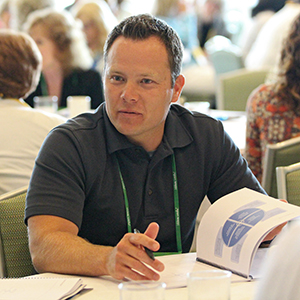 Leadership conference Participant with his conference workbook open
