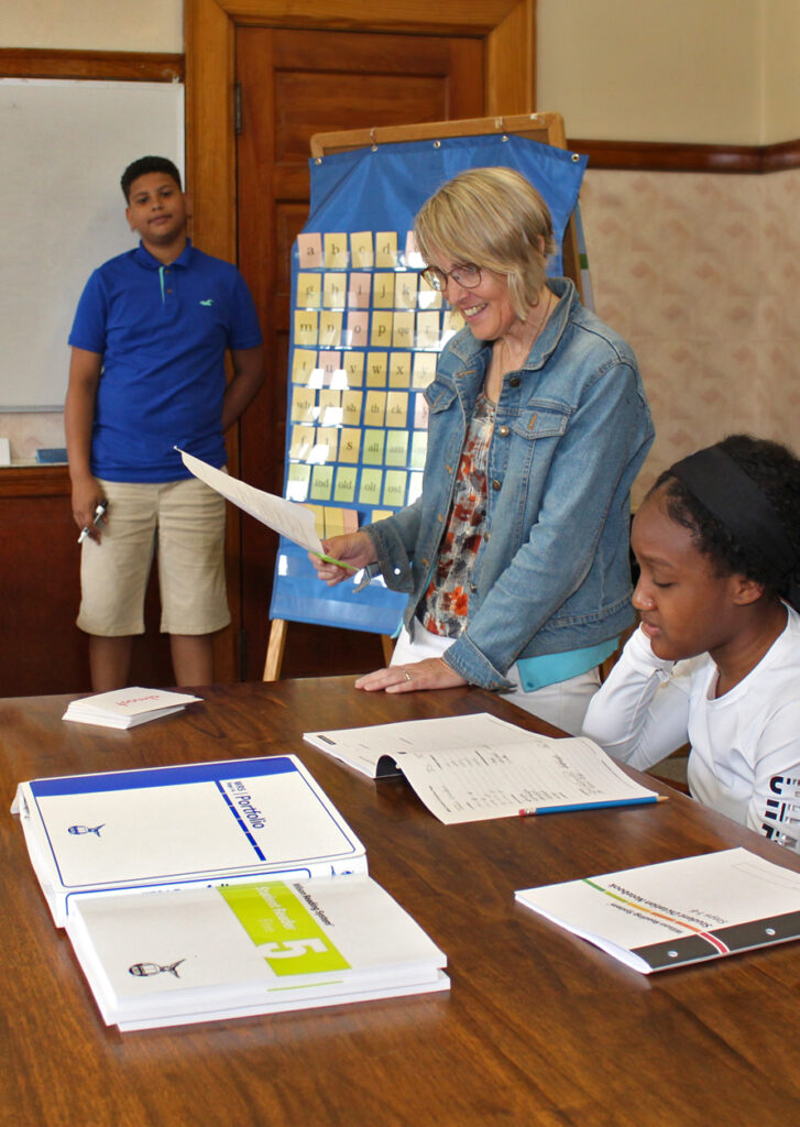 Teacher smiling while interacting with students