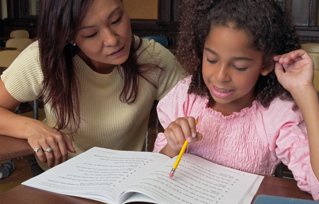 Teacher listening to student reading