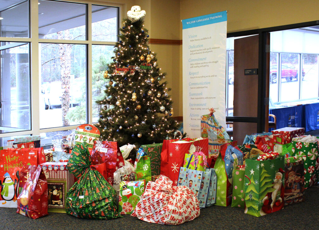 Wilson's Holiday tree with presents under it from Wilson Employees