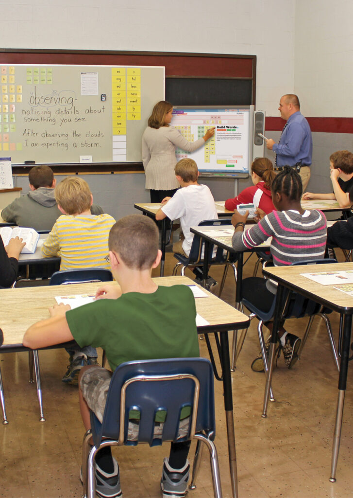 Teacher and student in front of class using Just Words Interactivities