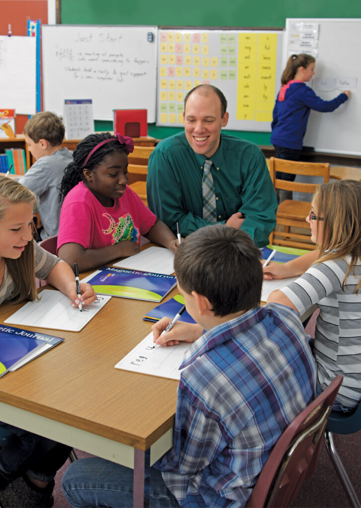 Teacher with students using dry erase boards