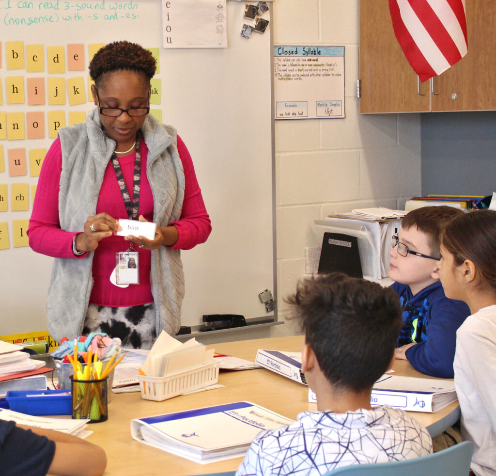 WRS teacher displaying word cards for students