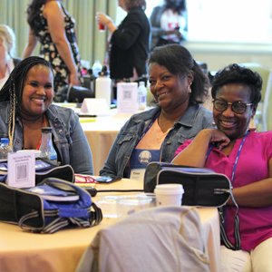 Trainers sitting at table smiling at camera