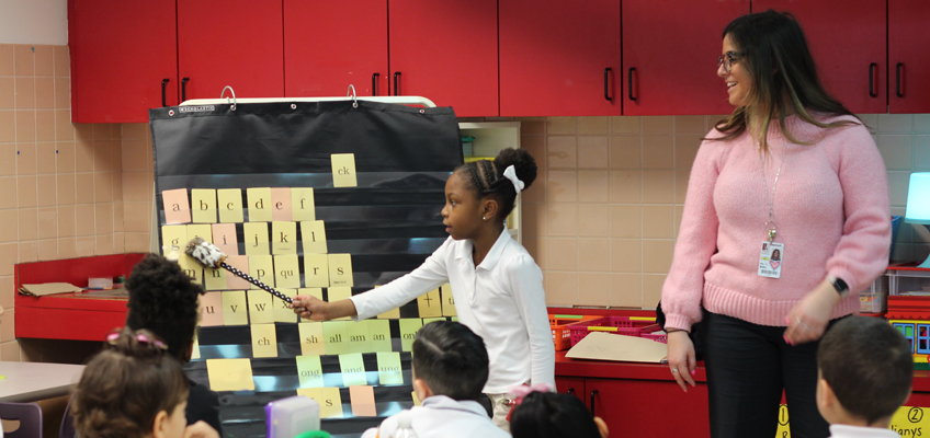 Student and teacher in front of a classroom