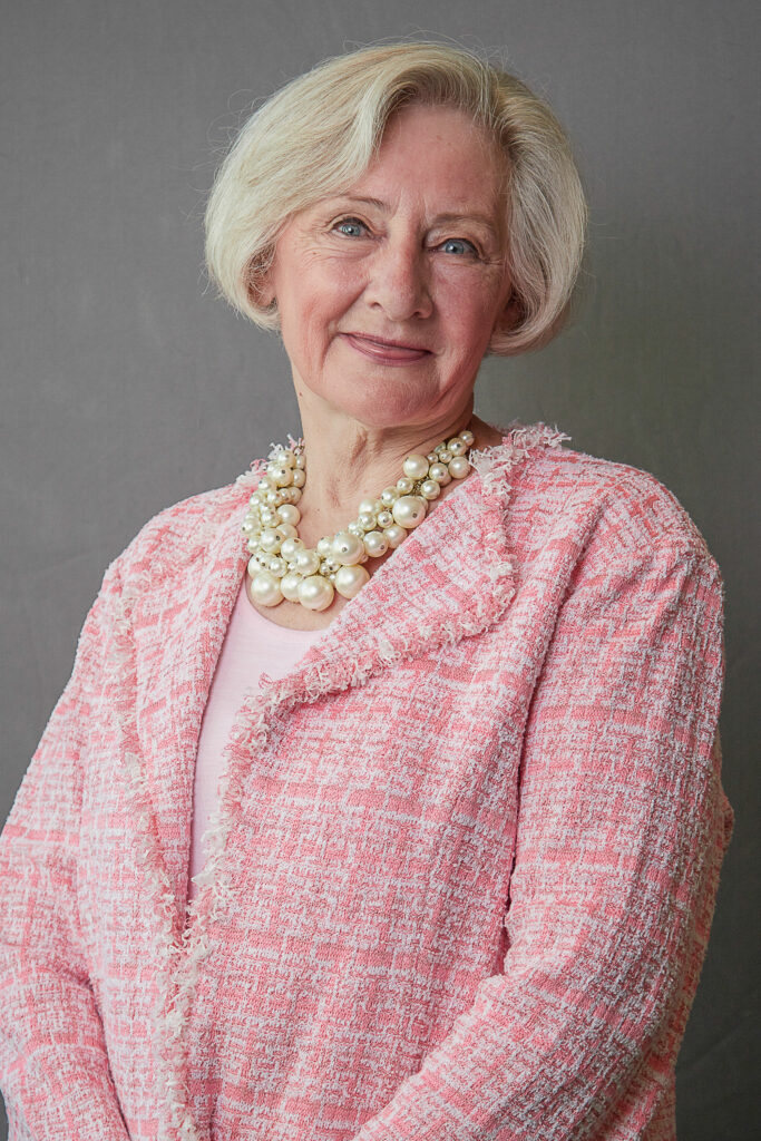 Headshot of a woman in a pink business suit