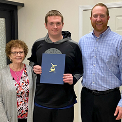 Chris Lee, Zack, and Kenneth pose for the camera. Zack is holding his WRS completion certificate.