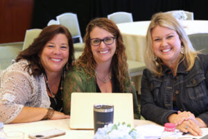 Three women smiling at the camera