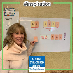 Woman standing in front of a board containing letter tiles that spell out I miss you.