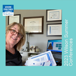 Woman sitting in front of a laptop with Wilson Summer Conferences handouts