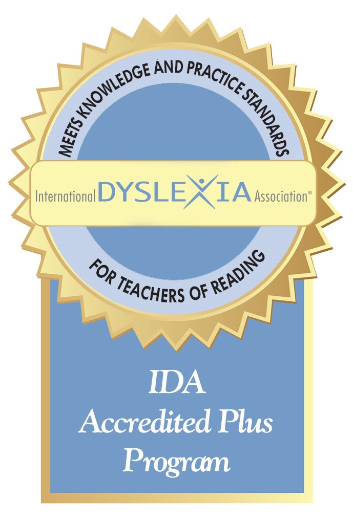 Gold and blue seal for the IDA Accredited Plus Program. Text reads: "International Dyslexia Association. Meets Knowledge and Practice Standards for Teachers of Reading.