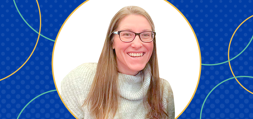 Smiling person with long hair and glasses, wearing a light-colored sweater. Background is blue with decorative circular patterns.