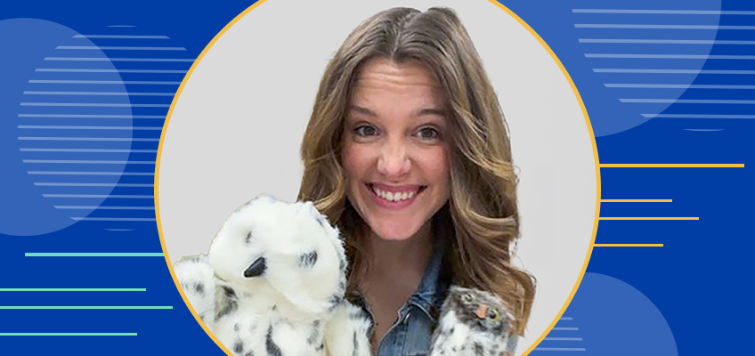 Smiling person with wavy hair holds a white plush toy against a backdrop featuring circular and linear patterns in shades of blue.
