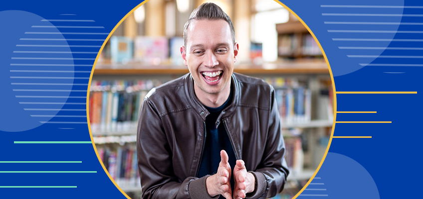 A person wearing a brown leather jacket, smiling and clapping hands. They are sitting in front of bookshelves. The background is a library setting with blurred books, enclosed within a stylized circular frame on a blue background.