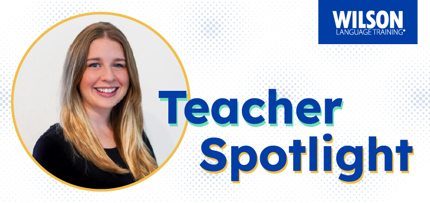 A graphic featuring a smiling woman with long blonde hair inside a circular frame on the left side. To the right, large bold text reads Teacher Spotlight in blue and green. In the top right corner is the Wilson Language Training logo in white and blue. The background has a subtle dotted pattern in blue.