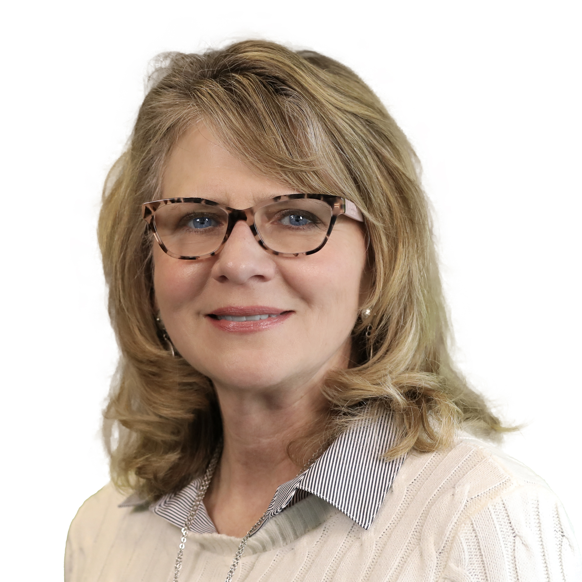 Smiling woman with glasses and long blonde hair. She is wearing a cream colored sweater standing against a white background.