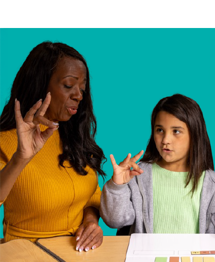 Adult woman and young girl seated at a desk, both using hand gestures to communicate, with a teal background.