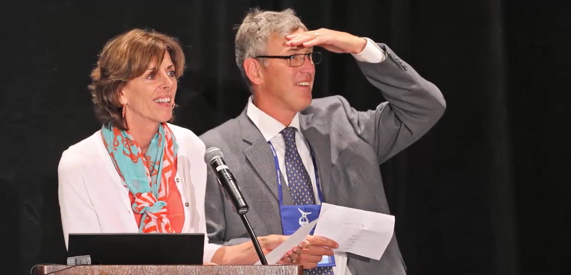 Man and woman at the 2014 Wilson Conference podium