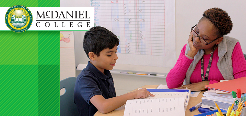 McDaniel College student working with a teacher on dyslexia certification materials