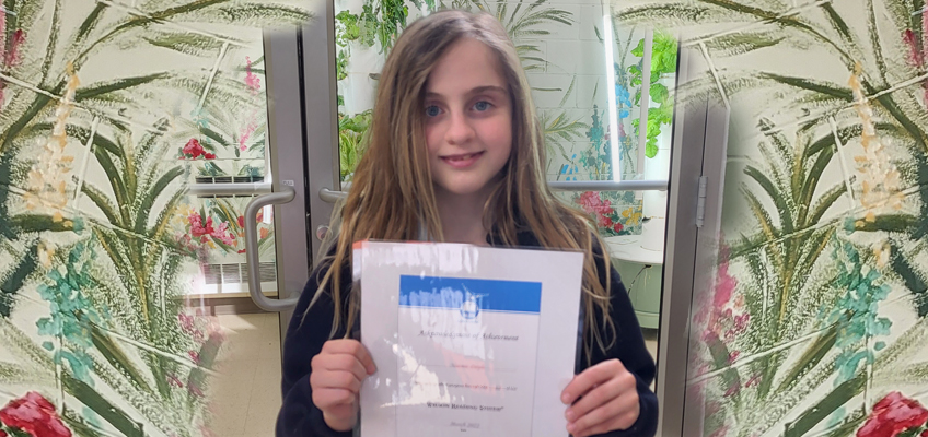Noémie holds a reading challenge certificate, showcasing her superpower.
