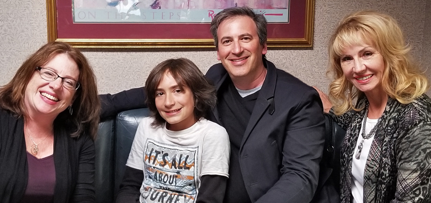 Family with son, father, and mother smiling, discussing dyslexia support.