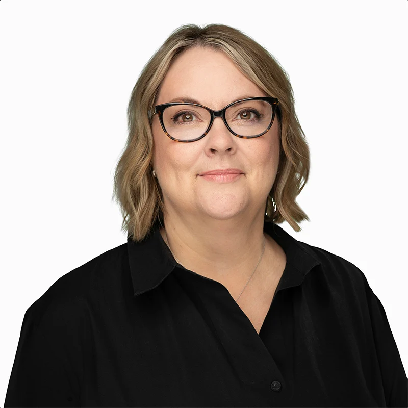Smiling woman with glasses wearing a black shirt