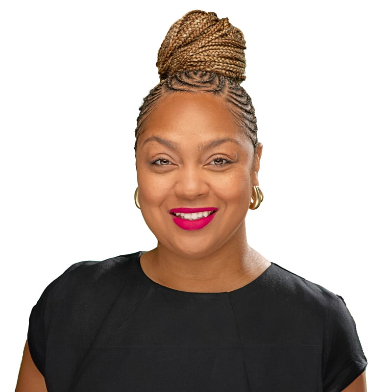 A smiling woman with braided hair up in a bun. She is wearing a black shirt and red lipstick