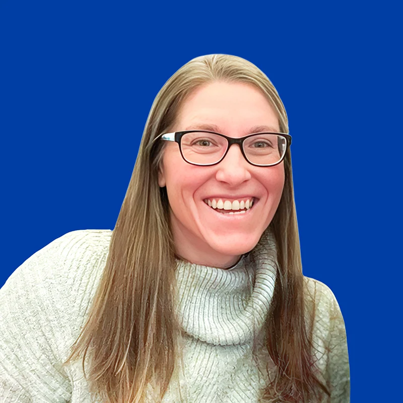 Woman smiling with glasses and a sweater