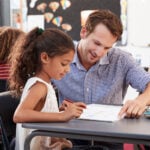 Teacher and student working on literacy instruction together.
