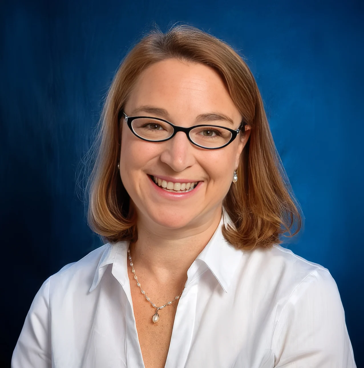Smiling woman with glasses, speaker at 2027 Wilson Dyslexia Conference